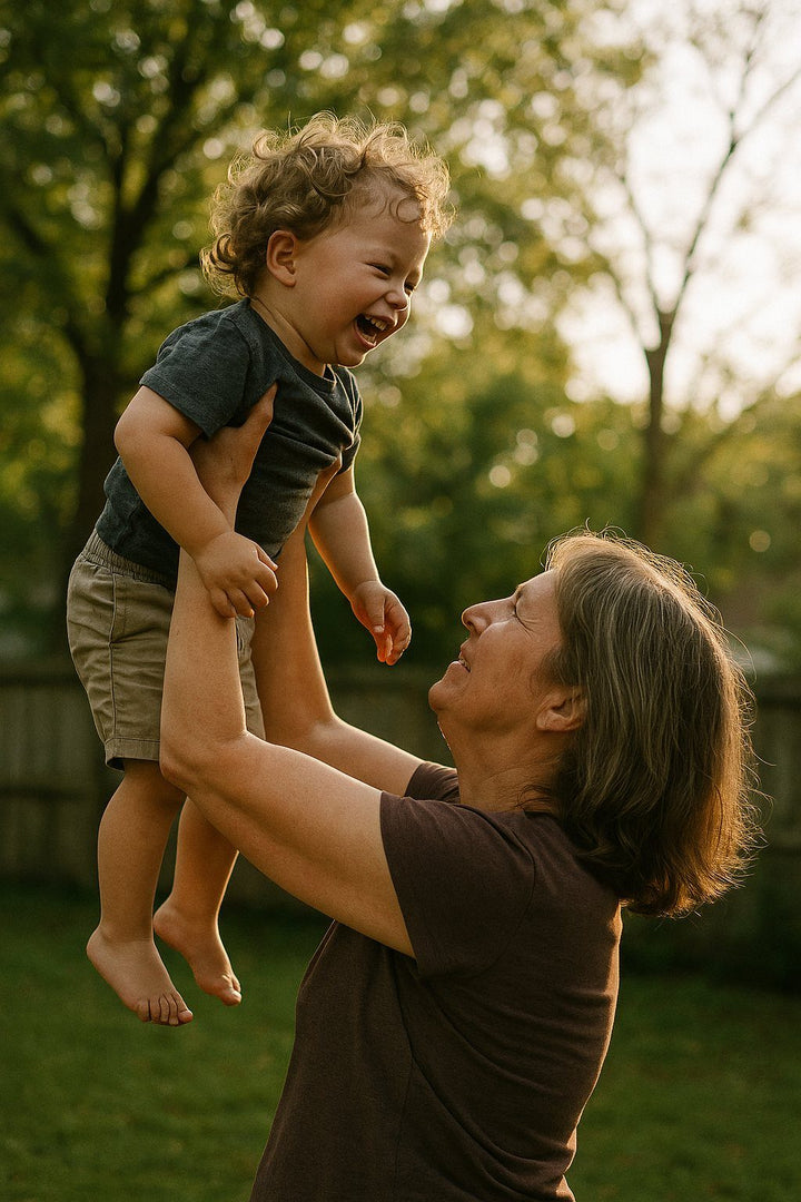 Grandmother lifting her grandchild in the garden
